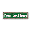 A rectangular vintage green tin sign with distressed edges and white text that reads Your text here.