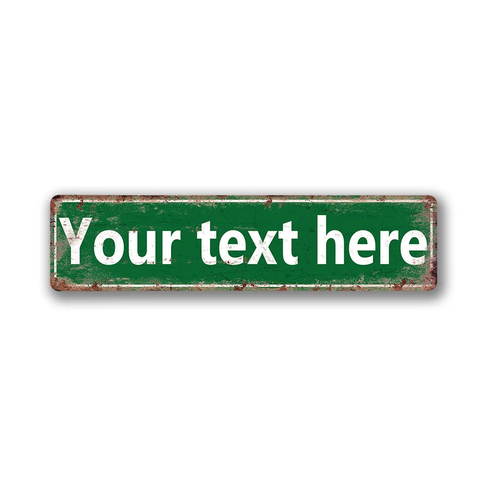 A rectangular vintage green tin sign with distressed edges and white text that reads Your text here.