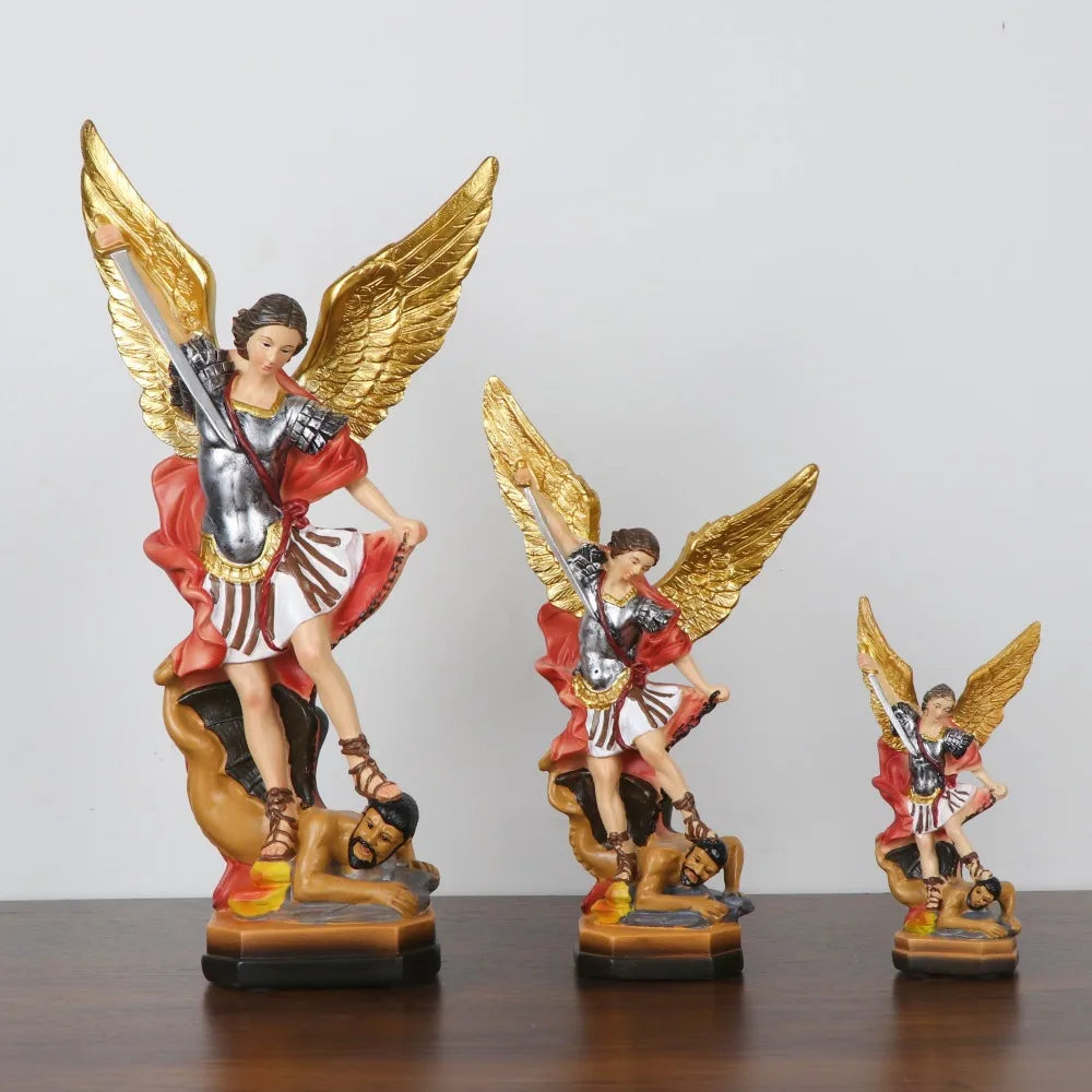 A resin statue of Saint Michael the Archangel with golden wings and armor.