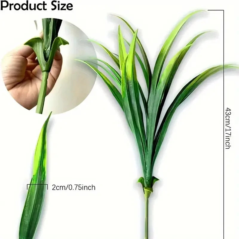 A tall, green artificial grass plant with long leaves is shown next to a hand for size reference.
