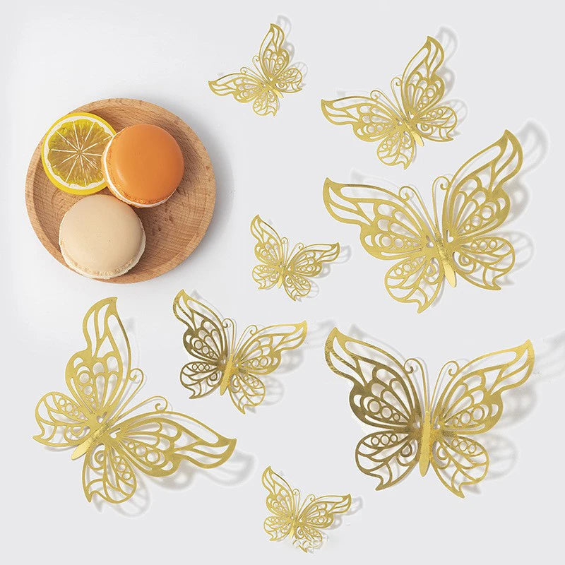 A set of gold butterfly wall decor featuring various sizes and a round orange and beige cosmetic product.