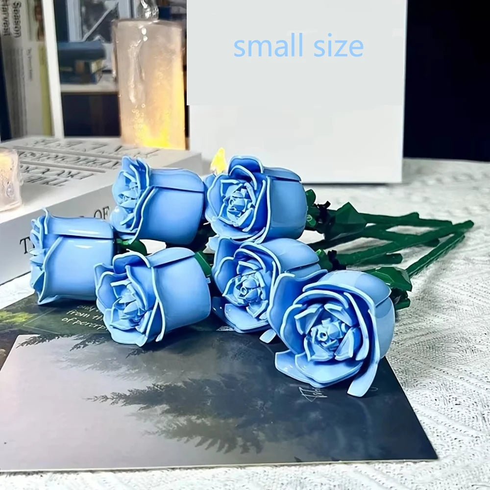 A small bouquet of blue rose flower building blocks displayed on a dark surface.