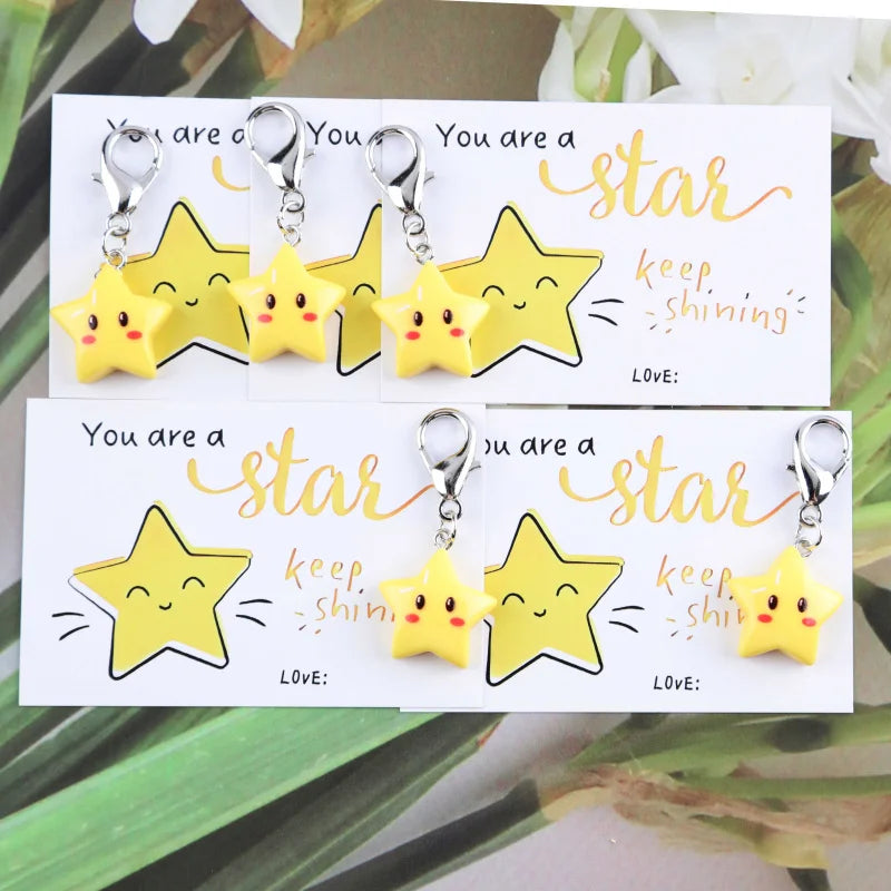 A set of inspirational star keychains featuring yellow and gold stars with text encouraging people to be a star and keep shin