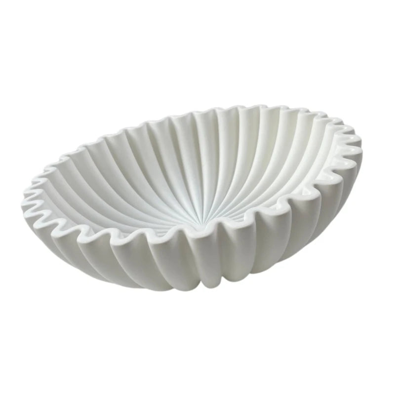 A white modern ruffle scalloped decorative bowl with vertical fluting.