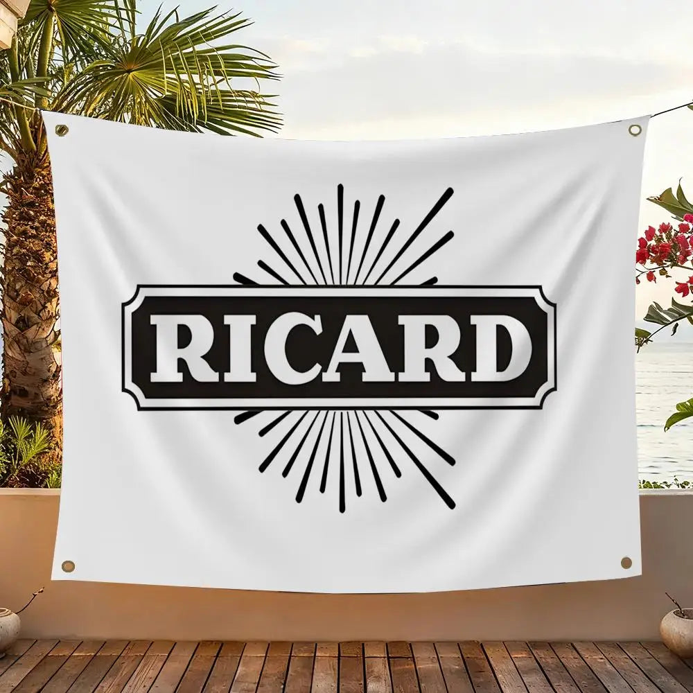 A white flag featuring the name RICARD in black text surrounded by radiating sunburst lines, displayed outdoors.