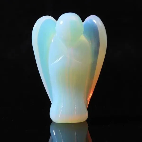 Hand-carved angel crystal figurine with a pale blue translucent glow