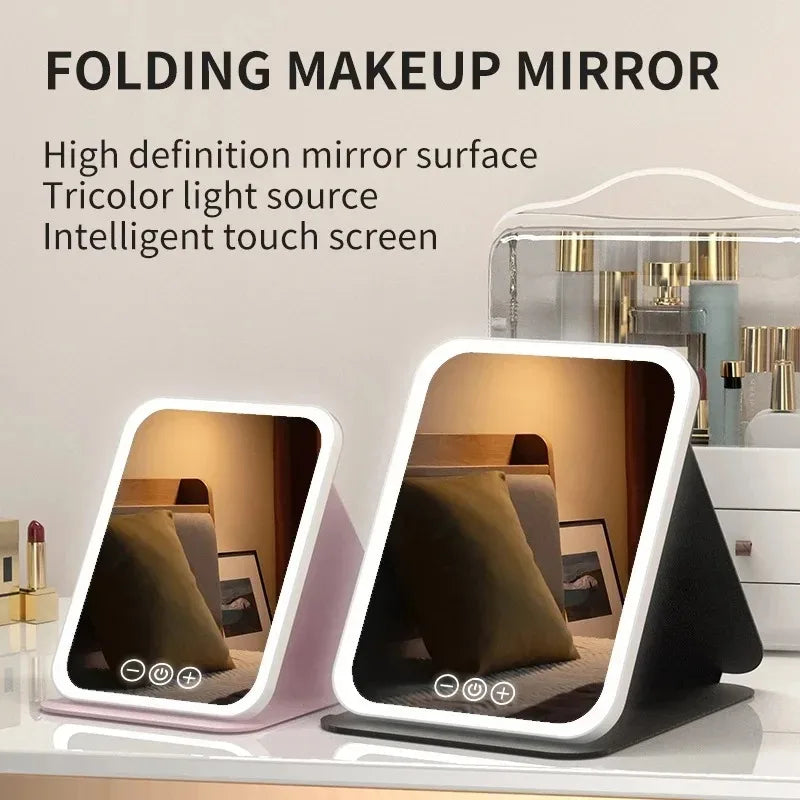 A folding makeup mirror with a high-definition surface and intelligent touch screen displayed on a white surface.