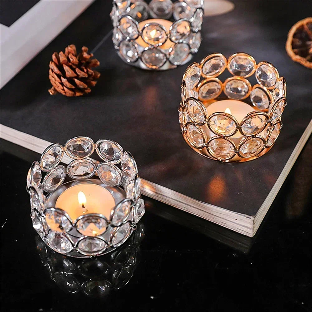 A set of romantic crystal tealight candle lantern holders with intricate glasswork displayed on a dark surface.
