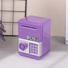 A purple mini piggy bank and money box with a silver keypad is shown on a light surface.