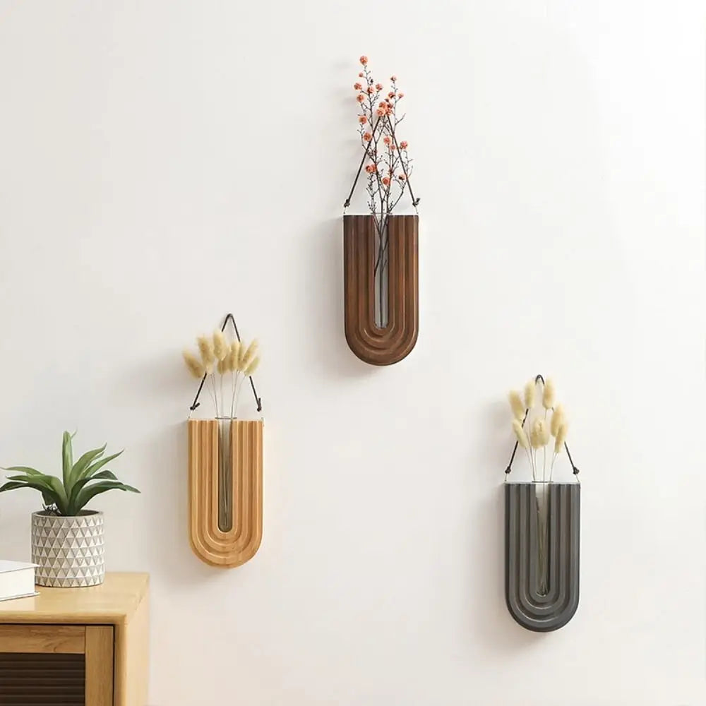 A set of handcrafted wooden wall-mounted hydroponic plant vases displaying dried floral arrangements.