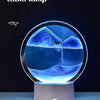 A sand painting table lamp featuring a glass globe with an underwater landscape of blue and purple colors.