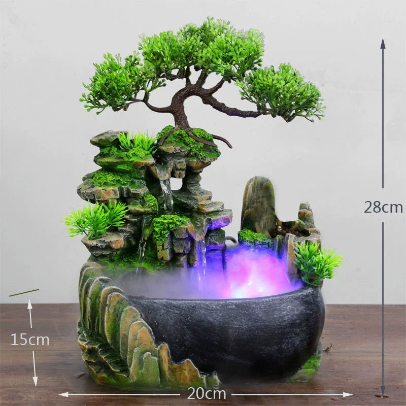 A resin waterfall desktop fountain featuring a mossy rock structure and illuminated water flow.