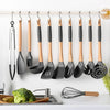 A set of ten S-shape stainless steel hanging kitchen utensils, including spatulas and forks, are displayed on a white shelf.
