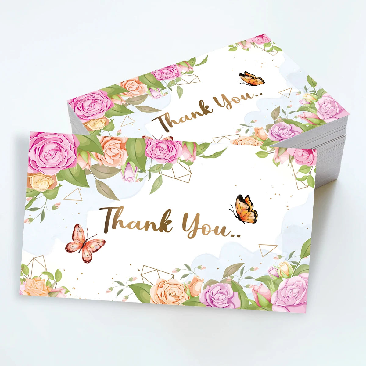 Ein Set rosa und Pfirsichfarbener Dankeskarten mit Schmetterlingen und Aquarellgrünzeug.