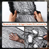 Hands stretching black gauze fabric to show how it stretches and tears