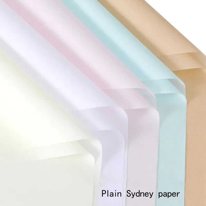 A stack of various colored plain Sydney paper sheets shown at an angle.