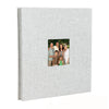 A grey linen front scrapbook memory book with a photo of a family.