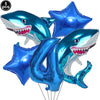A blue shark foil balloon decoration with a toothy smile, used for an ocean-themed party.