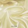 Cream satin fabric draped in soft folds for sewing and DIY projects