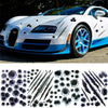 A white sports car features a blue accent stripe and a detailed decal pattern of bullet holes on the body.