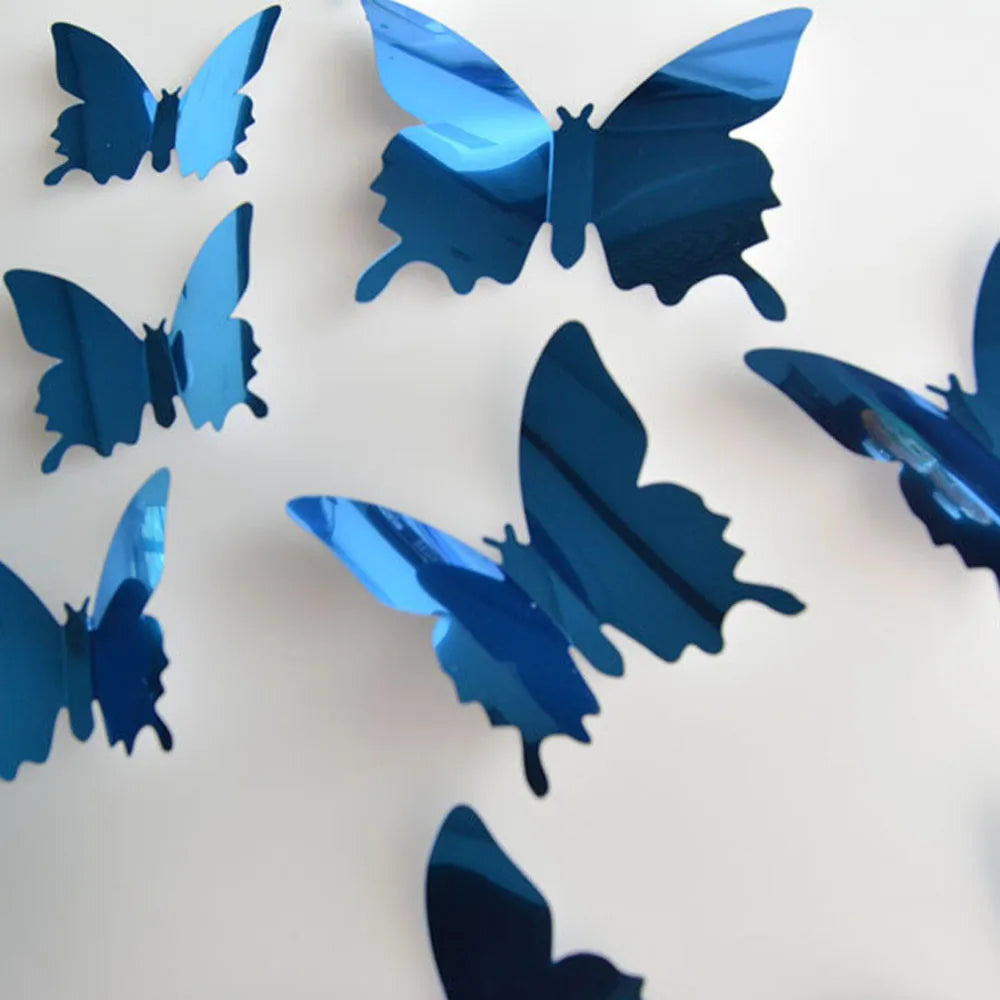 A collection of twelve iridescent blue mirror effect butterfly wall stickers scattered on a white background.