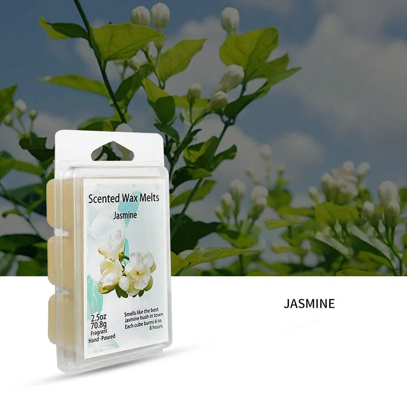 A clear plastic container of Jasmine scented wax melts with a label showing the product details and a background of green fol