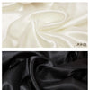 Two swatches of satin fabric are shown: one in off-white and one in black.