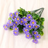 A bouquet of purple silk daisies with green leaves arranged for home decor.