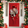 A red door decorated with a torn Santa face and surrounded by festive greenery and ornaments.