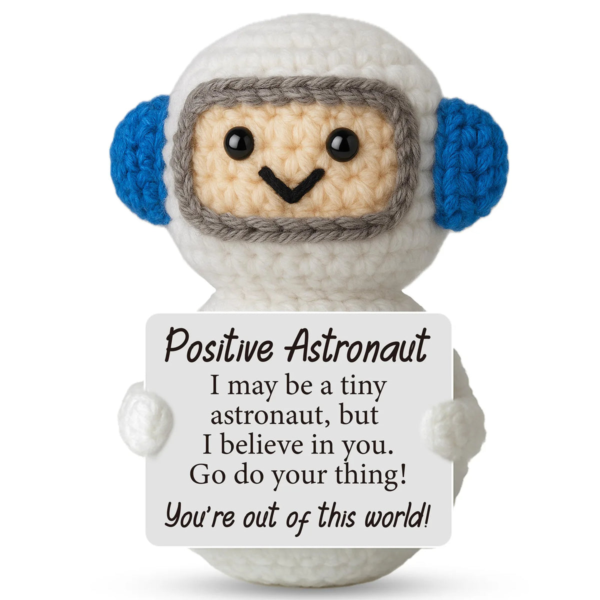 A handmade crochet ornament of a friendly astronaut with a light beige body, gray helmet, and blue ear accents.