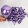 A hand holds a purple latex balloon and a pile of purple satin ribbons for a party set.