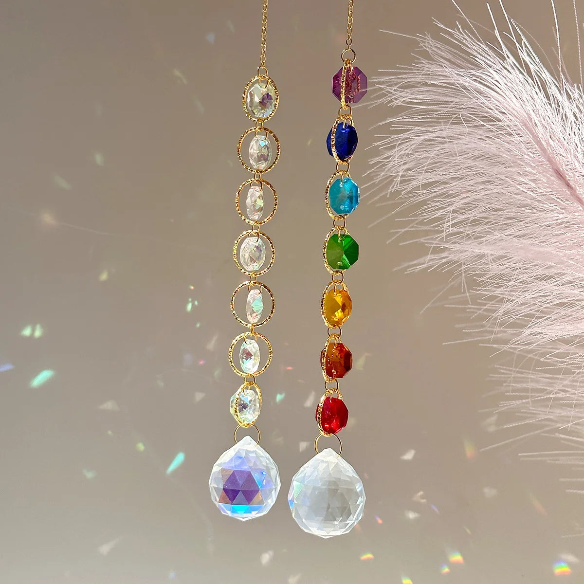 A pair of long, delicate gold-toned earrings featuring a string of colorful gemstone beads and faceted crystal drops.