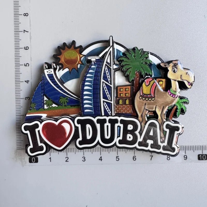 A collection of wooden fridge magnets featuring landmarks like a sail, palm tree, and camel, with the text I love DUBAI.