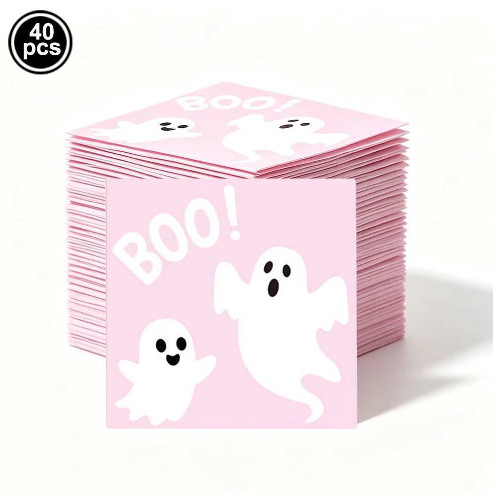 A stack of pink ghost Halloween party tableware featuring white ghosts and the word BOO!