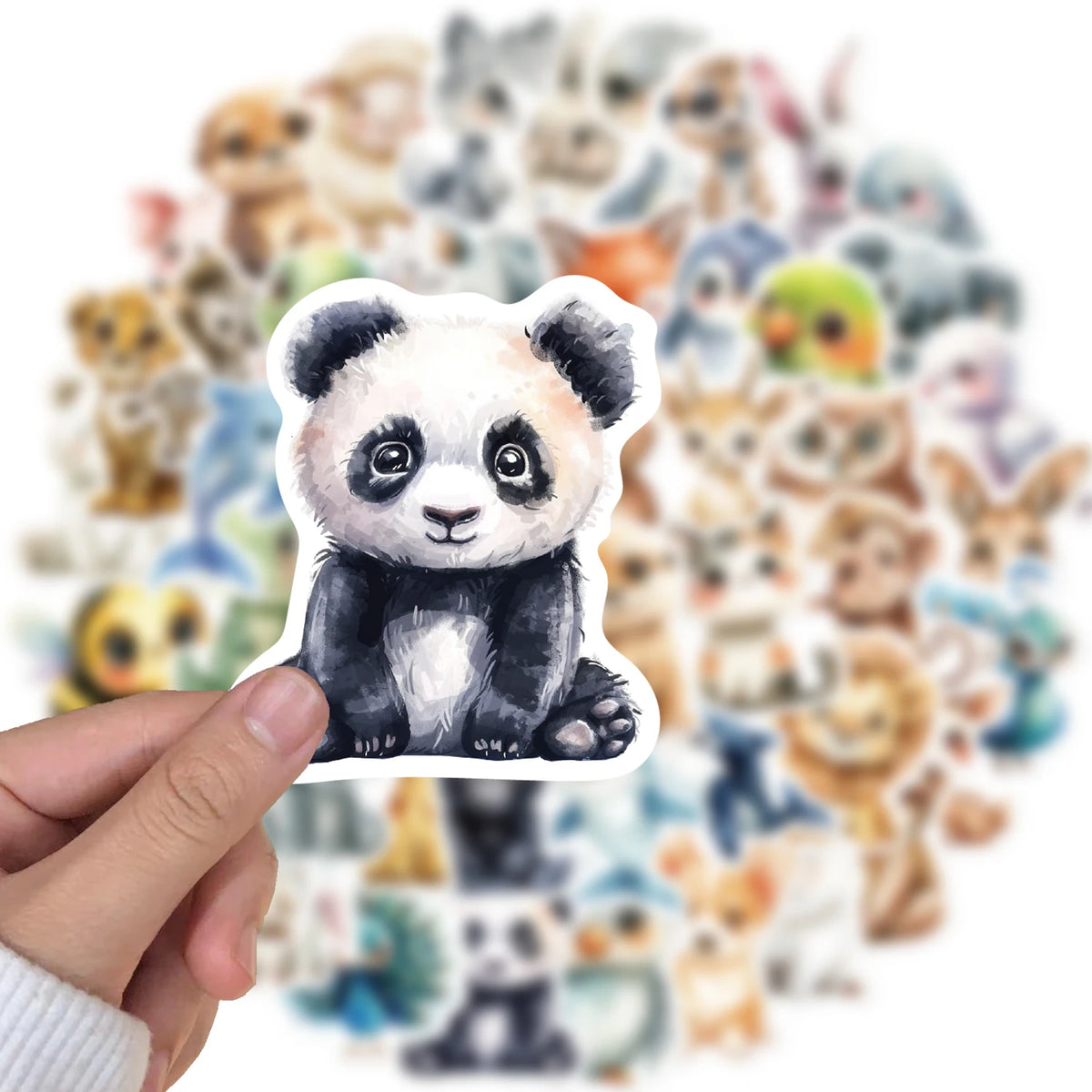 A hand holds a white watercolor sticker featuring a cute panda face surrounded by other watercolor animal stickers.