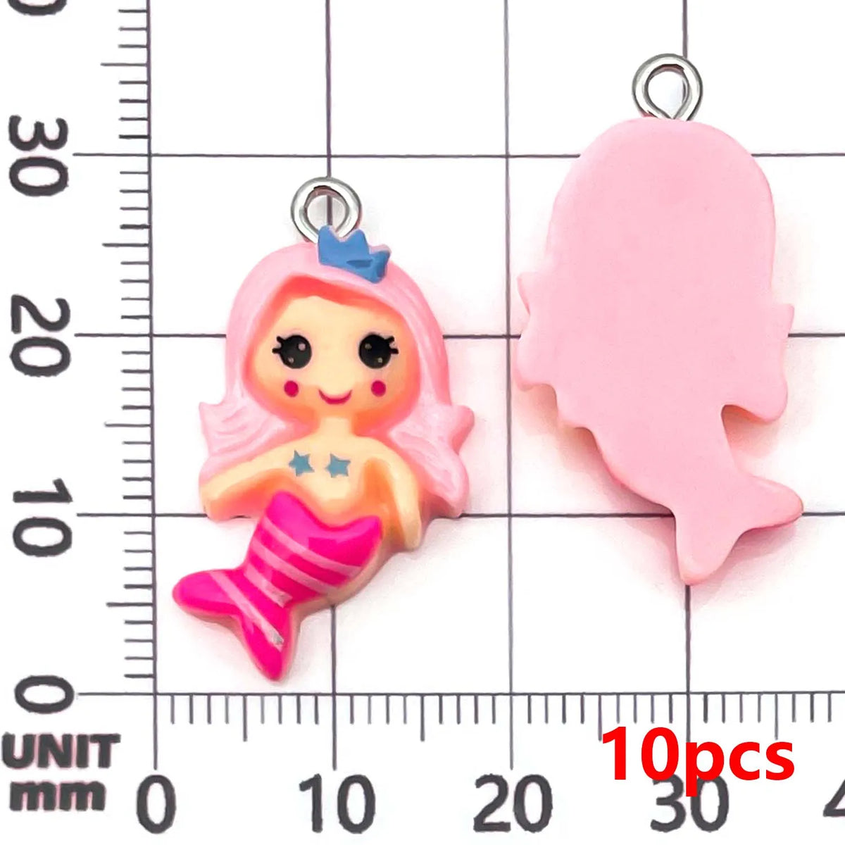 Pink resin mermaid princess charm and a separate pink mermaid tail charm shown against a millimeter ruler.