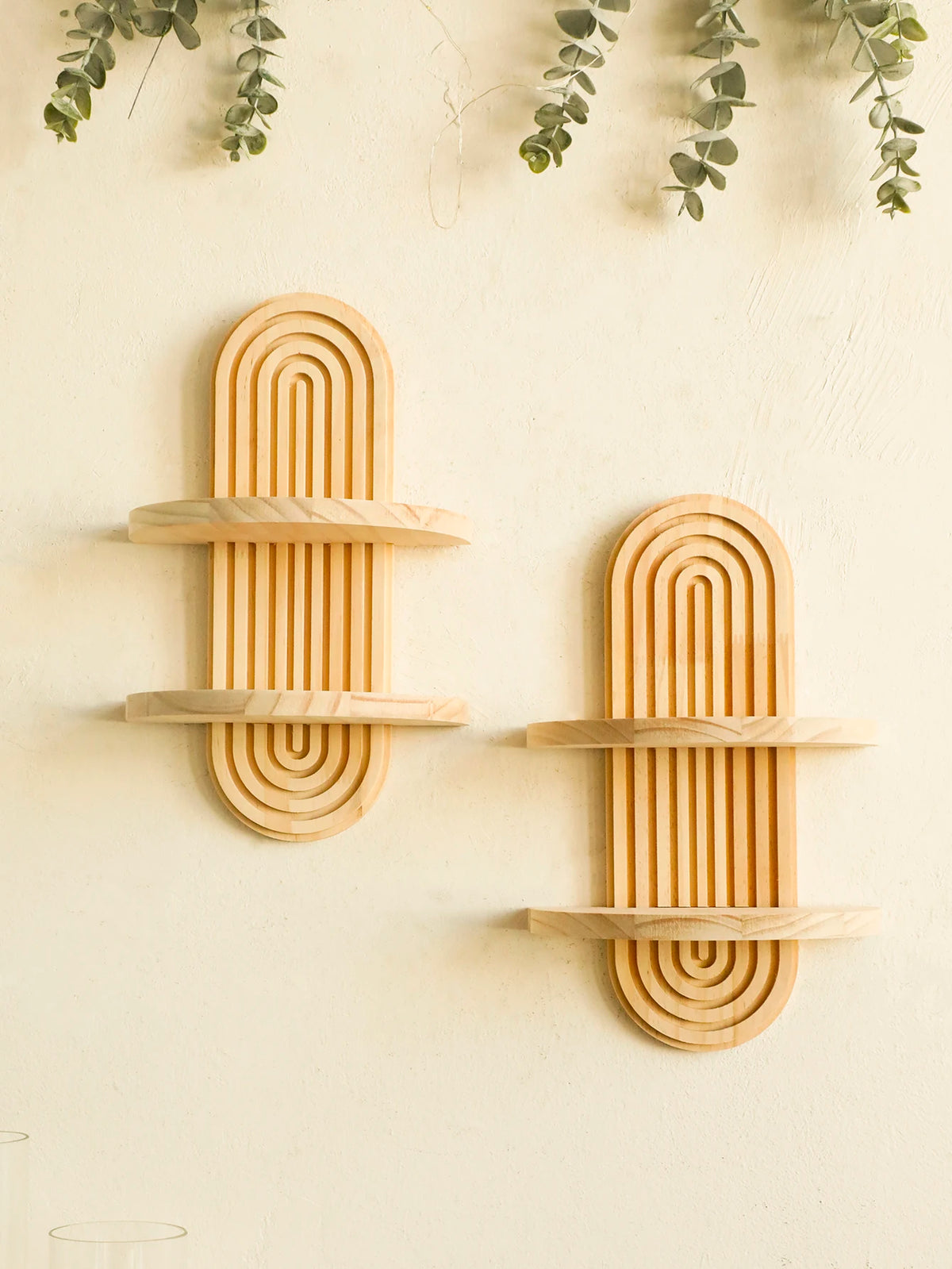 Two wooden geometric wall shelves with vertical slats mounted on a light-colored wall.
