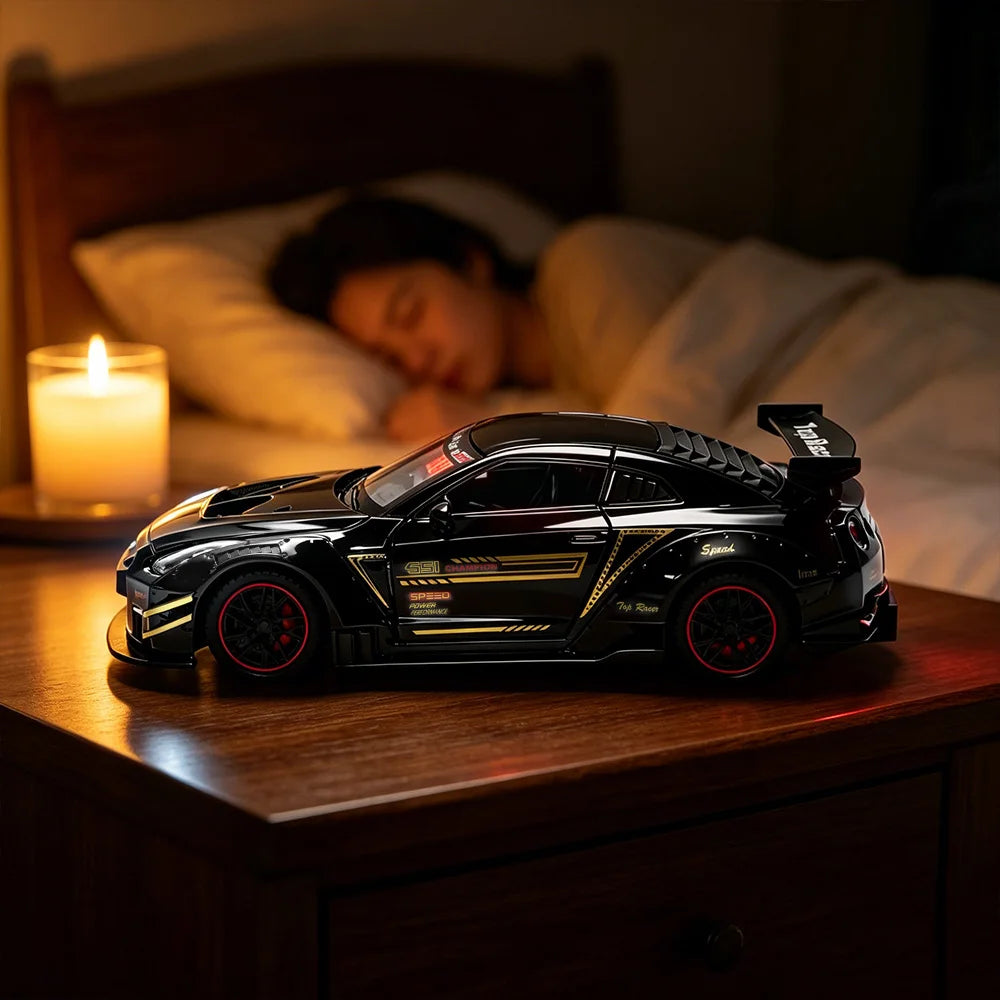 A black remote control car model is displayed on a wooden surface next to a lit candle.