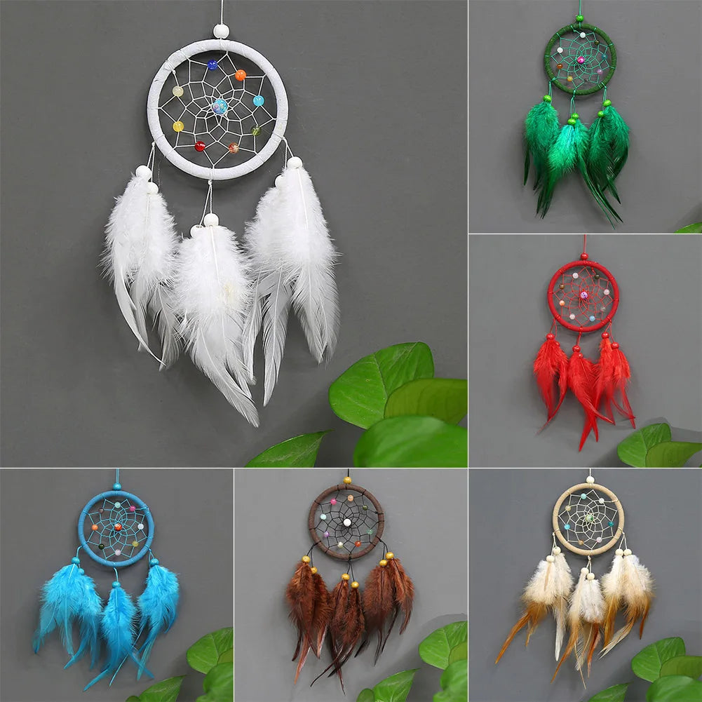 Handmade feather dreamcatchers in various colors and styles displayed against a gray background.