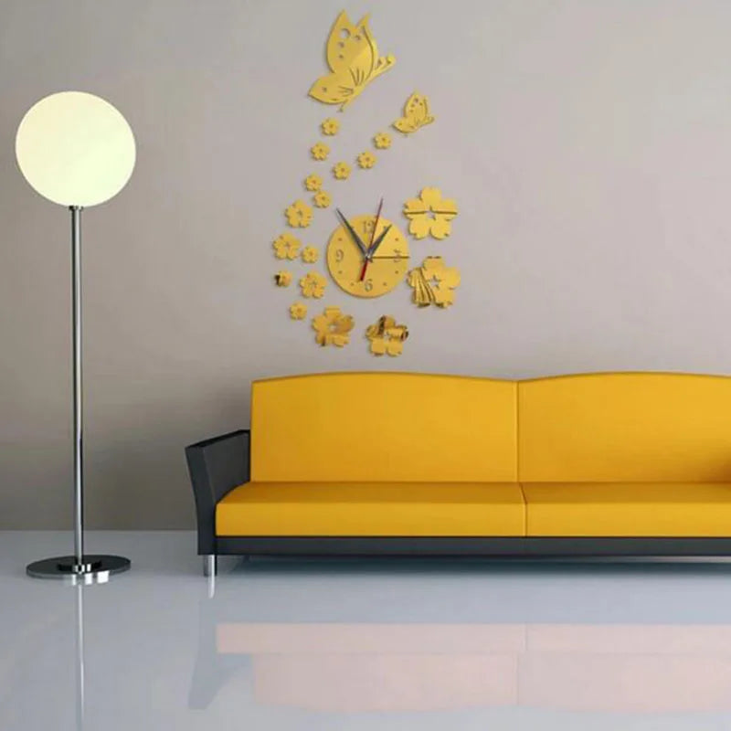 A modern acrylic wall clock featuring a butterfly and floral design mounted on a light gray wall above a yellow sofa.