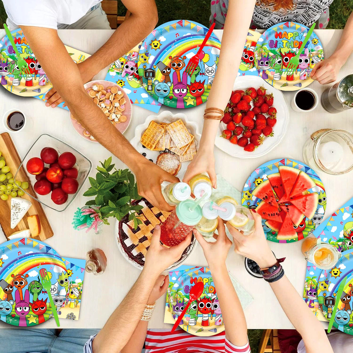 A table filled with colorful birthday party supplies including plates, fruit, and various toys for a celebration.