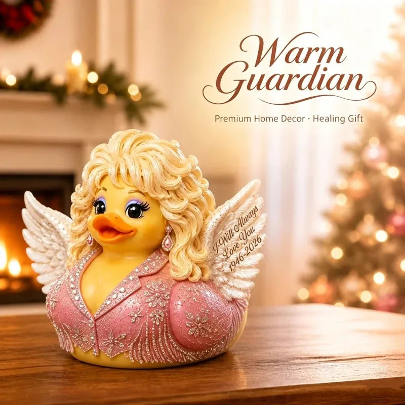 A yellow resin figurine of a duck with pink wings and curly blonde hair, displayed on a wooden surface.
