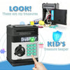 A black electronic treasure keeper piggy bank with a keypad and a coin is shown next to various treasures.