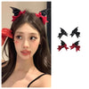 A set of black devil horn and bat wing hair clips in black and red for a Halloween costume