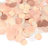 A pile of round tissue paper confetti dots in various shades of blush pink and nude.