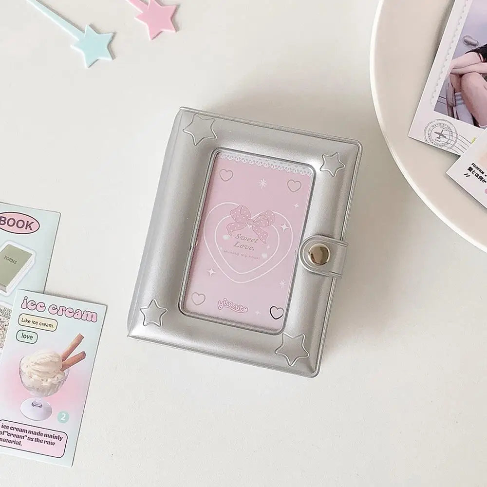 Silver compact photo card holder album with a pink heart-shaped photo card visible inside