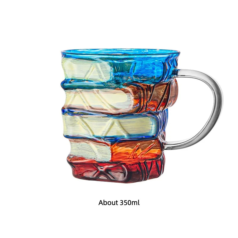 Hand-painted mug featuring a stack of books with blue, white, and reddish-brown colors.