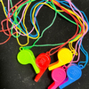 A collection of colorful plastic whistles on lanyards in various bright colors like red, green, yellow, and blue.