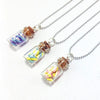 Silver necklaces featuring glass cork stoppers with dried floral inclusions for DIY decor
