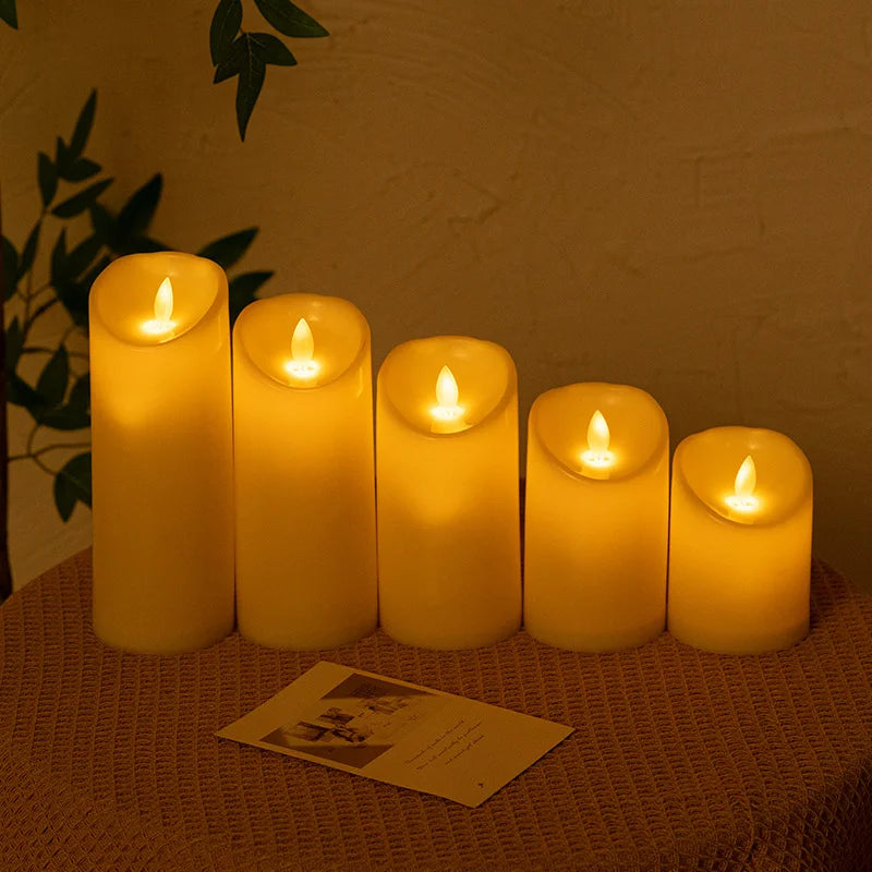 A row of glowing yellow LED candles set on a table, casting a warm light against a neutral background.